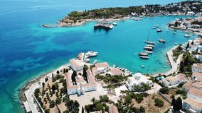 Aerial drone bird's eye view video of picturesque church of Agios Nikolaos in historic and traditional island of Spetses, Saronic Gulf, Greece