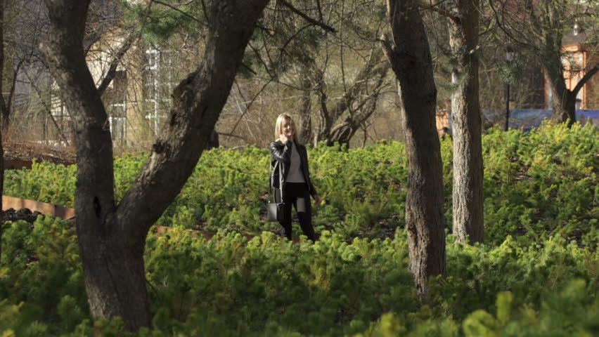 Smiling blond girl is taking a walk