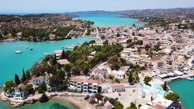 Aerial drone bird's eye view video of famous and picturesque yacht dock seaside fjord village of Porto Heli with turquoise and emerald clear waters, Argolida, Peloponnese, Greece