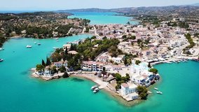 Aerial drone bird's eye view video of famous and picturesque yacht dock seaside fjord village of Porto Heli with turquoise and emerald clear waters, Argolida, Peloponnese, Greece