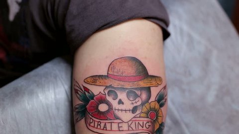 Close-up of a tattoo with a skull on the hand of a man. Tattoo parlor. Tattoo.
