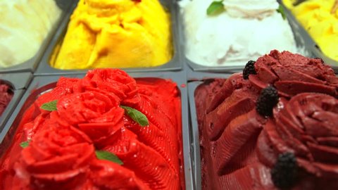 This panning video shows a delicious looking display of gourmet gelato flavors.