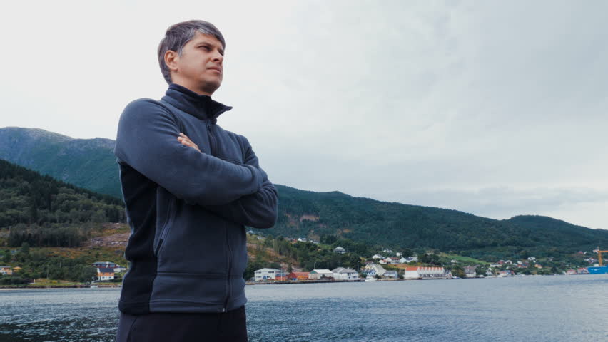 Male tourist meditatively peering at beautiful landscape. Beautiful scenery or sea landscape.