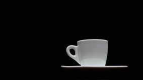 A cup of hot coffee on a black background