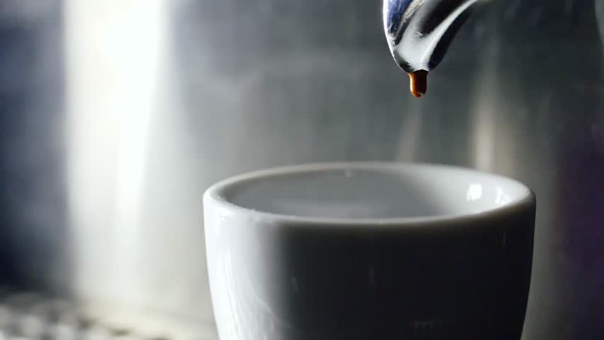 Pouring coffee into cup from electric coffee machine shooting in 4k resolution in slow motion Royalty-Free Stock Footage #1012414526