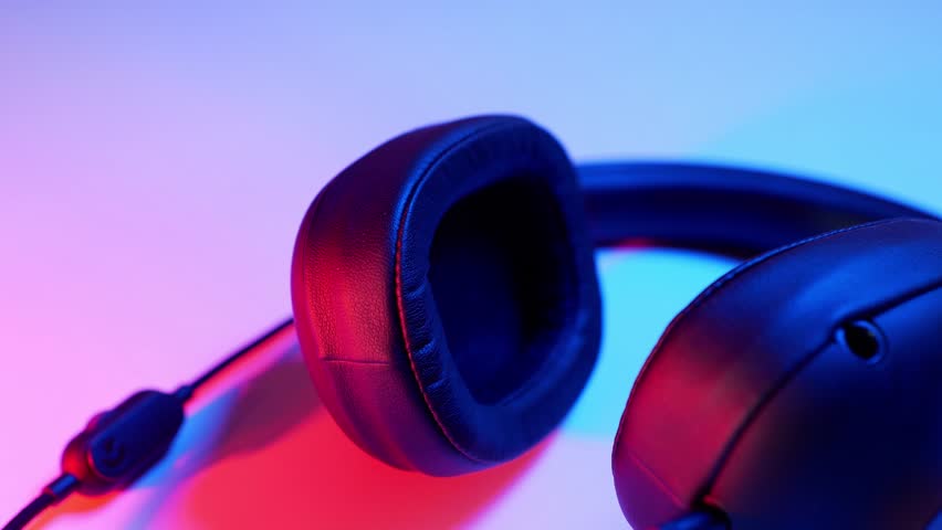 Modern headphones on clolored background