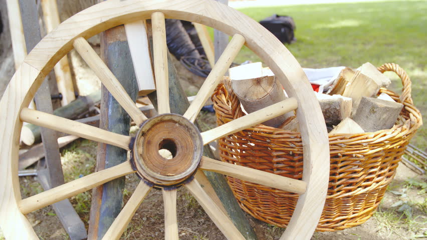 Carriage wooden wheel before wrapping into iron close-up 4K. Dolly shot of wooden wheel in focus before iron forged to protect the wooden elements.