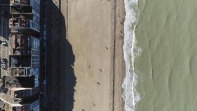 Aerial footage Knokke-Heist beach and boulevard the city is located along North Sea on Belgian border with the Netherlands and is Belgiums best-known and most affluent seaside resort 4k quality