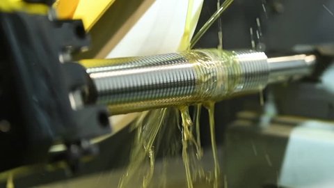 Thread cutting with oil lubrication. CNC machine metalworking.