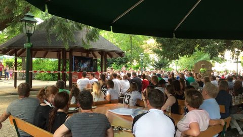 PASSAU / GERMANY, 17 June 2018: German football fans in an open air pub silently watch as the German national football team is defeated by Mexico on the 2018 World Cup.
