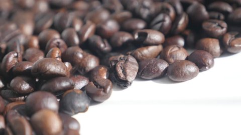 Coffee beans on white background 4K slow pan footage