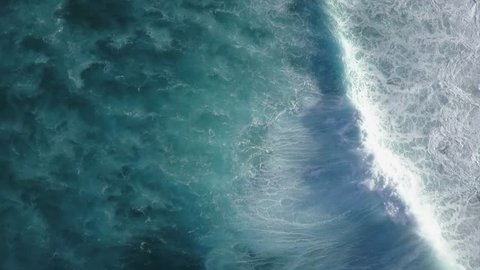 Big Waves rolling from above in Oahu, Hawaii Top down 4k drone view on blue turquoise ocean, breaking waves and whitewash. Sunny day over the sea. Huge swell and foaming on North Shore 
