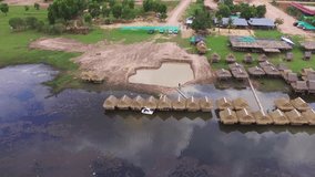 A beautiful drone video of Romlech Lake in Kampot province in Cambodia. This big lake surrounded by mountains, it's a water reservoir for rice fields and plantation with beautiful beach.