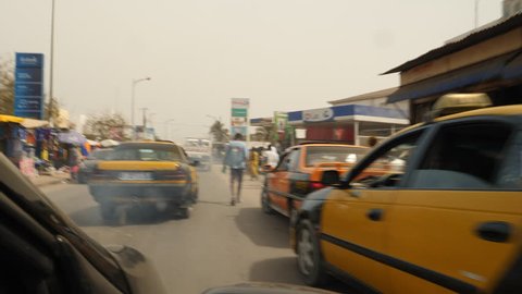 Senegal, Africa, June 2018. Old taxi creating cloud of exhaust fumes/air pollution. Dakar.