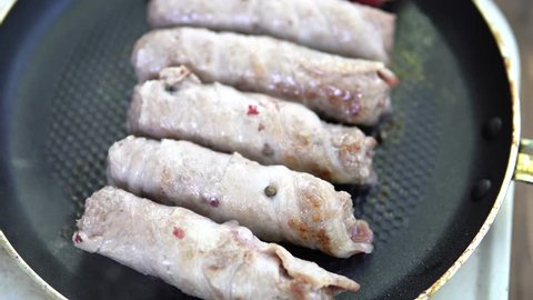 Preparation of meat dish from minced meat wrapped in bacon with white veins. Macro