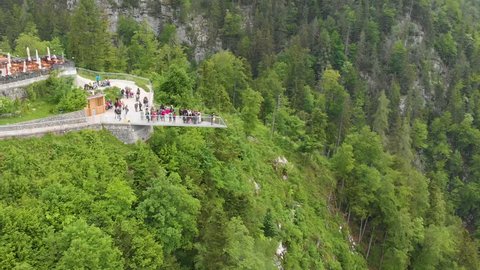 Aerial: anonymous tourists at Hallstatt Skywalk "World Heritage View" viewpoint