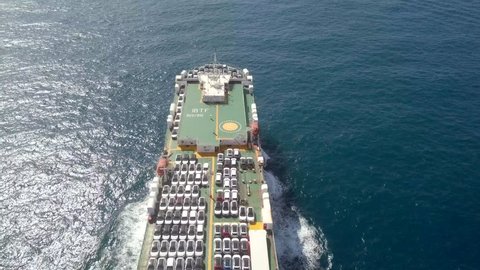 Aerial footage of a Large RoRo (Roll on/off) Vehicle carrier vessel cruising the Mediterranean sea.