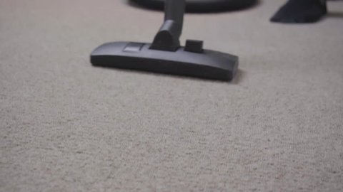 Vaccuming beige carpet