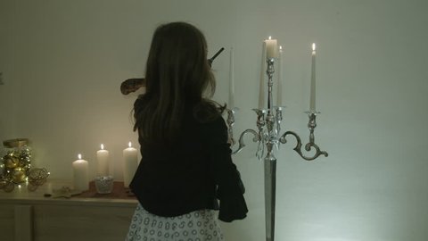 Young girl lighting a candles for celebration.Interior of beautiful living room decorated for Christmas / New Year. Stock Video