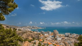 4K time-lapse video taken from the castle on the mountain in Cullera, Valencia, Spain. Beautiful, sunny day showing the coastline with blue skies, water and white, whispy clouds