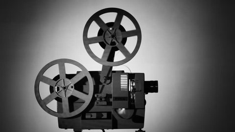 Movie projector 8-mm film.
The film projector is loaded with a film and a film is shown. Monochrome image.