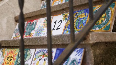 TAORMINA, SICILY/ITALY - JUNE 2018: Ceramic painting on the steps of a staircase in Sicily