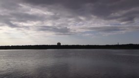Ripples of the lake and the movement of gray clouds. Time lapse video.