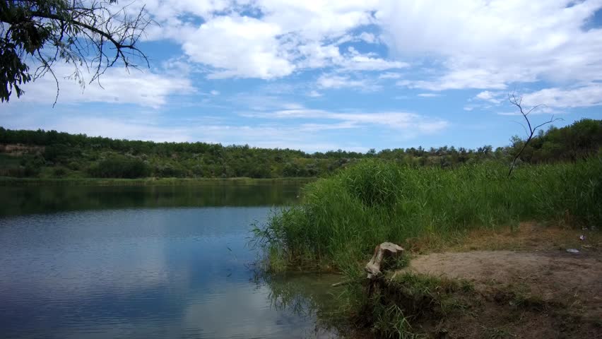male tourist on a bicycle traveling along the river bank