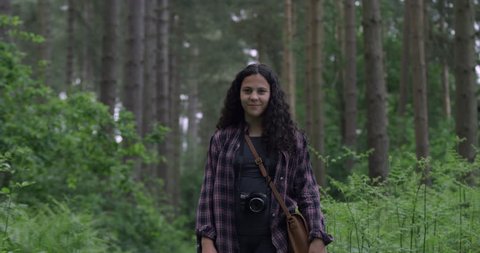 Portrait of Happy Beautiful Mixed Race Teen Girl Standing in the woods smiling. 