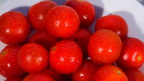 Salad tomatoes in a bowl glistening with water 4K