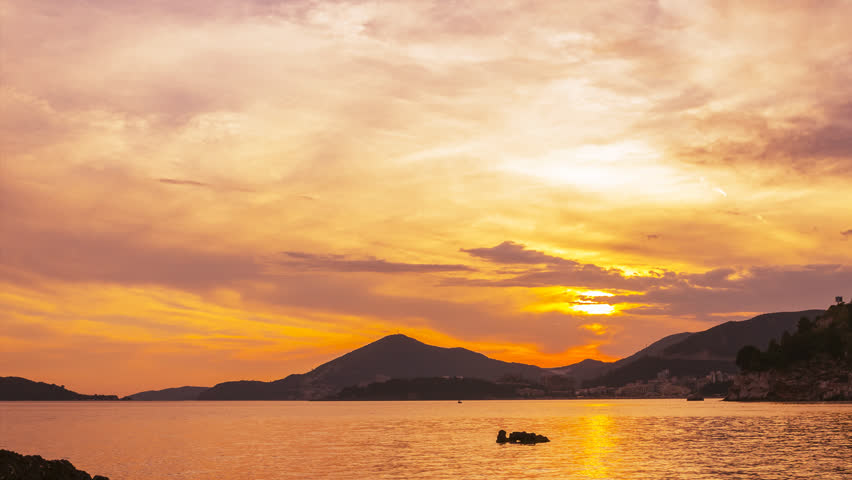 Time lapse, colorful sunset on Adriatic sea coastline,near the Budva city in Montenegro, gorgeous seascape