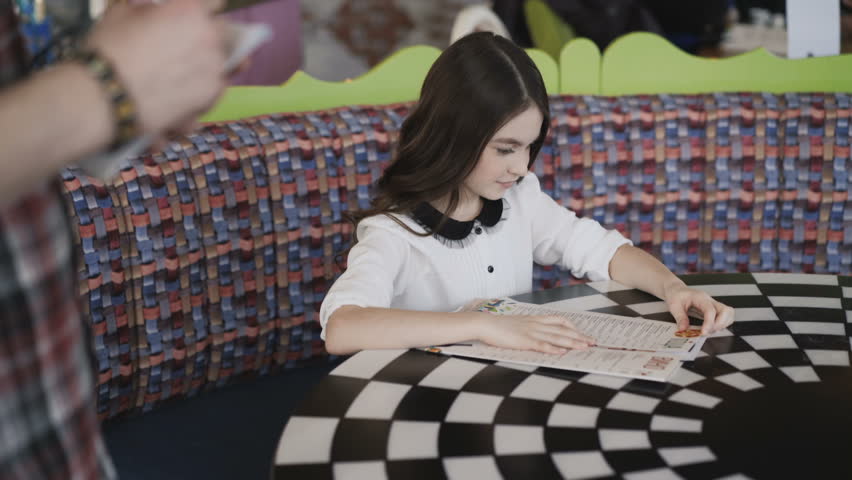 Pretty young and smiling girl making an order in cafe. 4K.