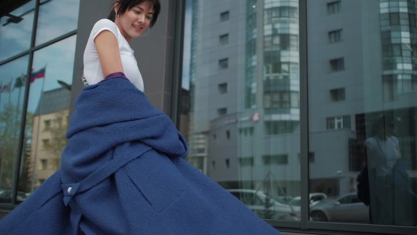 Portrait of an attractive girl in a blue coat. young fashionable woman