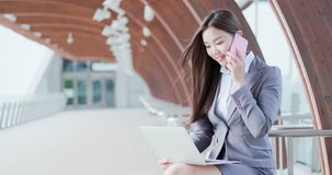 business woma use computer work and speak on phone