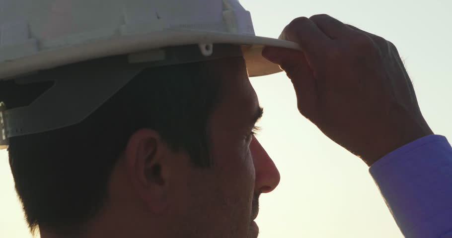 Portrait close up, of an engineer at sunset looking at the horizon proud of himself and of the project he has just made. Concept of: career, success, work and engineering. Royalty-Free Stock Footage #1012504916