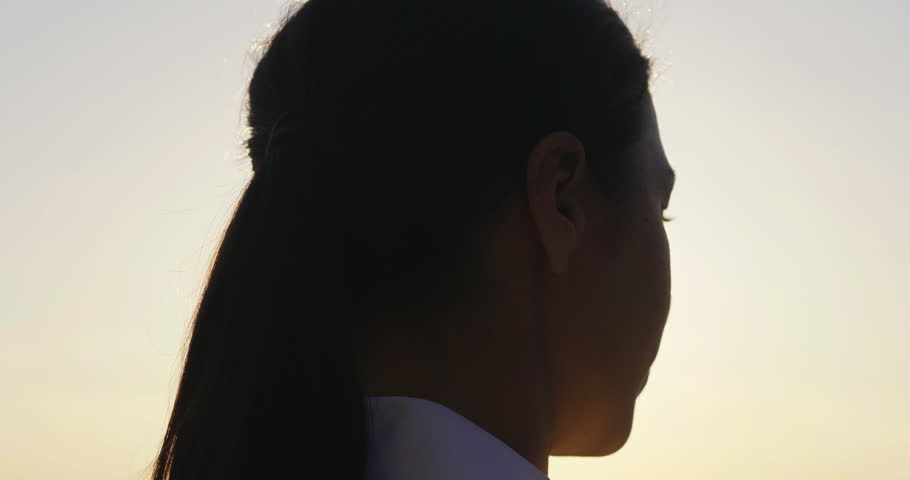 Slow motion close up of a woman engineer looking at the horizon proud of her work and putting a construction helmet on at sunset.Concept of: career, success, work and engineering. Royalty-Free Stock Footage #1012504922