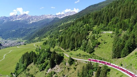 Bernina Express, red train of Bernina in Val Poschiavo. Aerial view