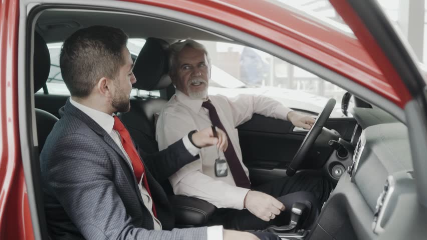 Happy client is getting the key of his new car. Business people. Proffesional sales man.