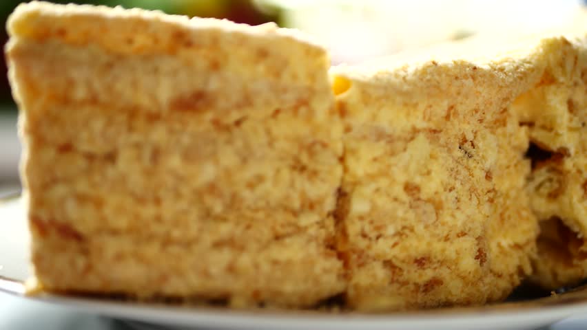 Napoleon cake with custard on platter. Dessert layered cake is chopped