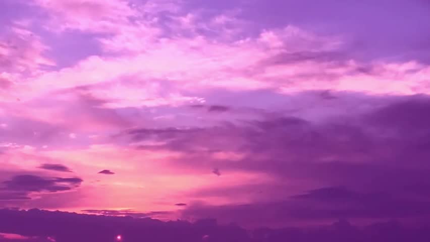 Clouds with orange, purple and black colors at sunset sky. Telephoto video of dramatic pink and purple clouds at sunset. 4K. Royalty-Free Stock Footage #1012520081