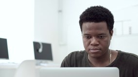 Concentrated African-American college student working on laptop in computer classroom - Powered by Shutterstock - Get 15% off with code: PIKWIZARD15