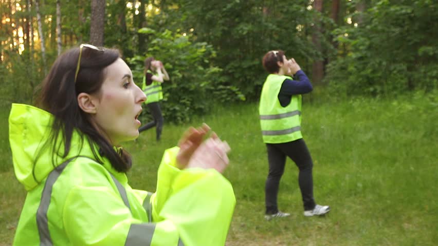A group of volunteers is in the woods in green vests, the search for the missing,steady shot slow mo