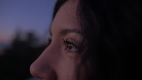 Close of Woman's Face and Eyes During Dark Sunrise/Sunset as She Admires the Colorful Blue and Purple Tones in the Sky