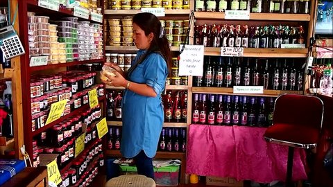 BAGUIO CITY, BENGUET PROVINCE, PHILIPPINES - JUNE 7, 2018: A local delicacy store owner arranges her products at her store