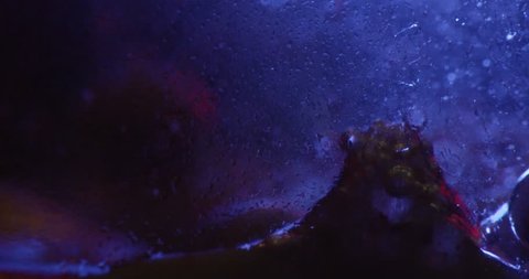 Color drops floating in oil and water over a colorful underground with oil painting effect. Shot on RED. 4K.