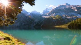 Amazing view of glacier lake Oeschinensee. Location Swiss alps, Kandersteg, Bernese Oberland, Europe. Scenic footage of beautiful nature landscape. Discover the beauty of earth. Full HD 1080 video.