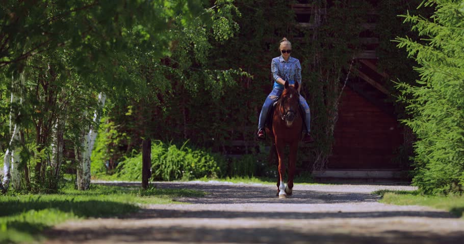 Young girl horseback riding beautiful chestnut mare in outdoor