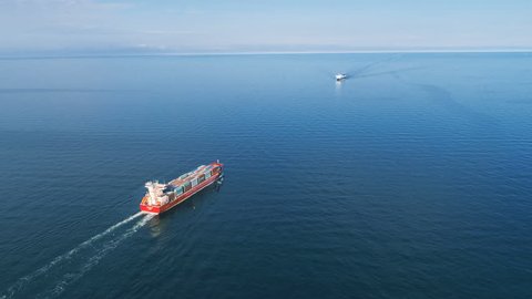 Aerial Timelapse of Container Ships Passing in the Sea
