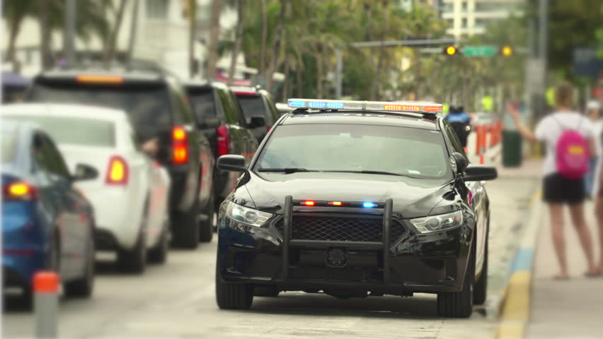 Miami Beach police car with flashing lights at Ocean drive - April 2018: South Beach, Miami, Florida, United States
