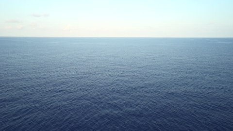 Aerial shot of open ocean. Flight over of open sea.